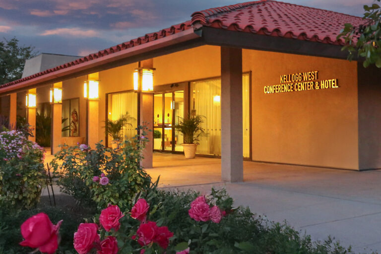 Exterior view of orange-lit hotel lobby entrance