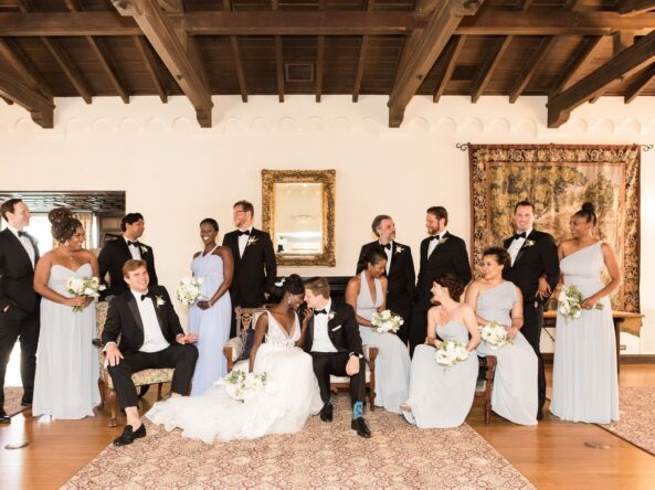 Wedding party poses for a photo at the Kellogg House main room.