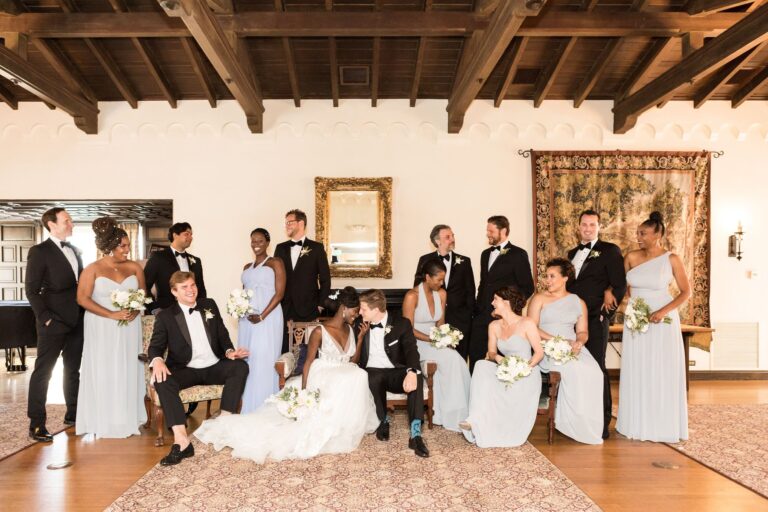 Wedding party poses for a photo at the Kellogg House main room.
