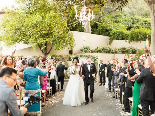 bride and groom walk up the aisle after wedding