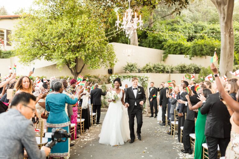 bride and groom walk up the aisle after wedding