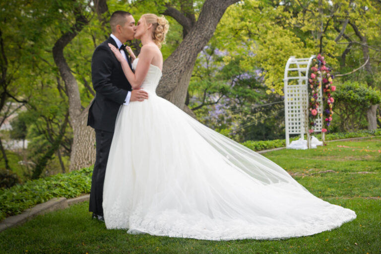 bride and groom kiss at Kellogg West outdoor wedding