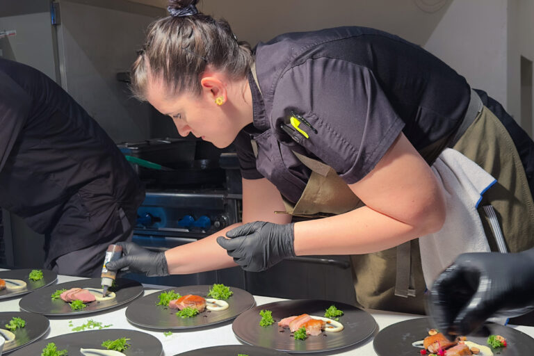 Chef Krista garnishing dinner plates
