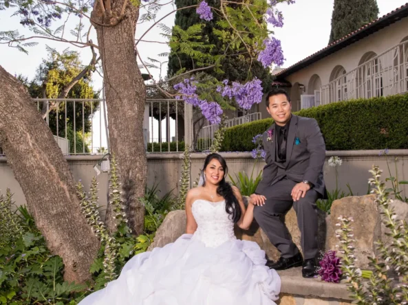 Bride and groom pose for photo in back yard of Kellogg House