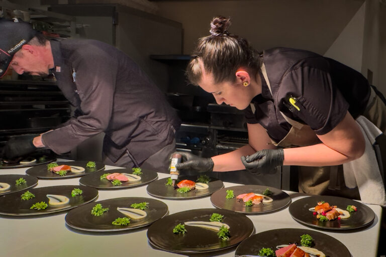 executive chefs plating duck entree